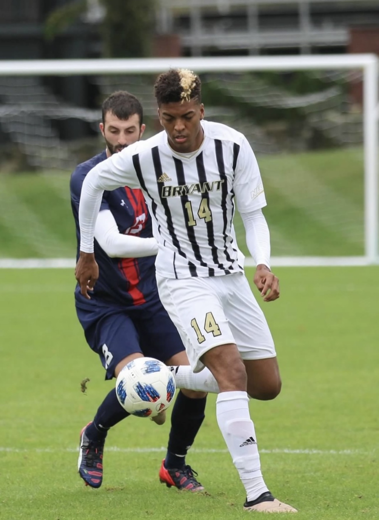 The Pathwai founder controlling the ball under pressure in his Bryant number 14 jersey